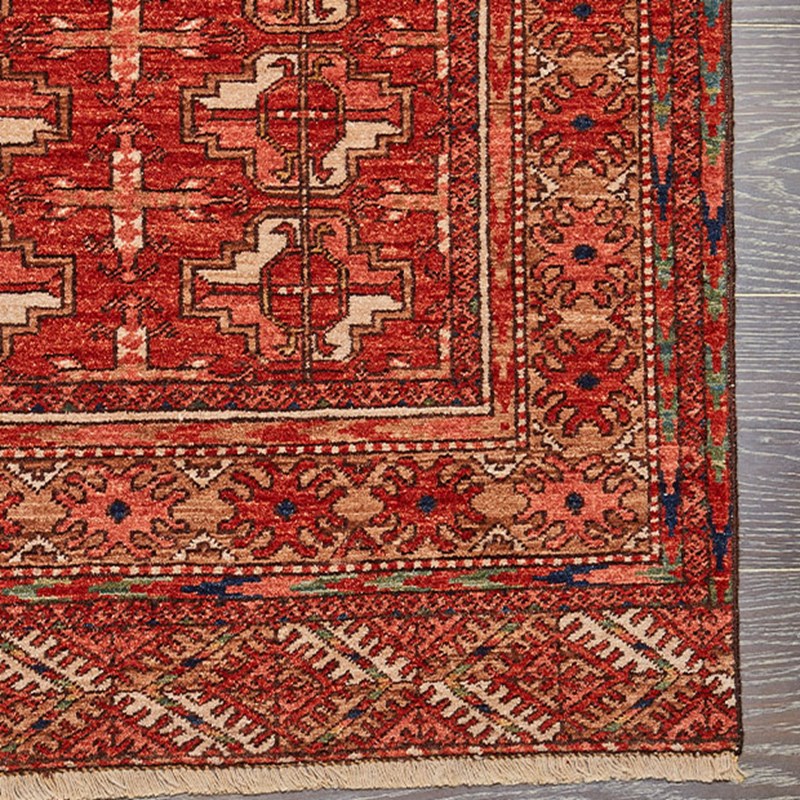 close up detail of Afghan carpet, with striking zig-zag motifs which take their cue from chevroned Mughal columns, woven through with jewel-box tones inspired by the materials of Doha’s Museum of Islamic Art.